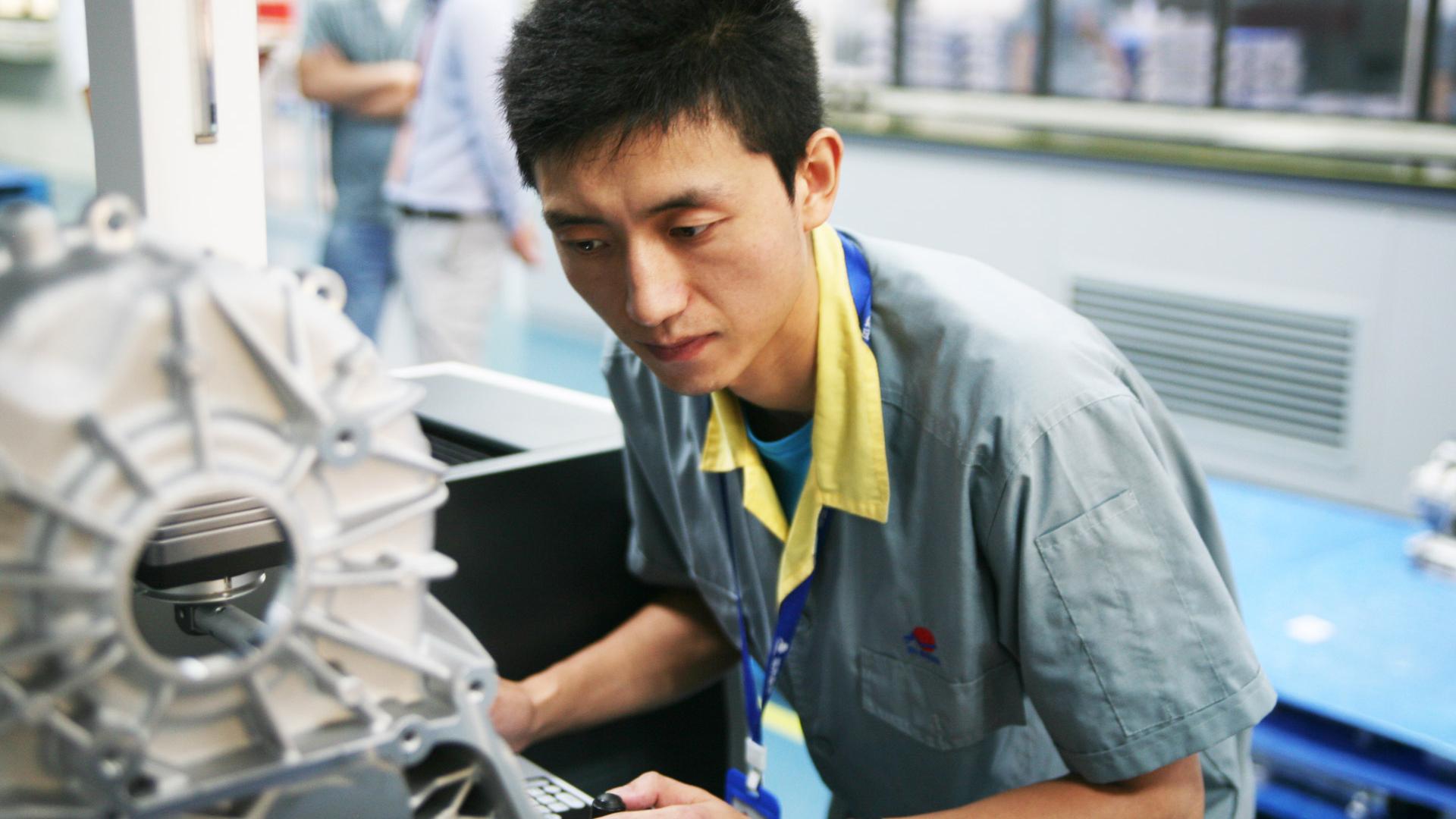 A metrology technician at a measuring machine at Xusheng.
